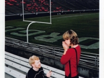 photo of man and woman in stadium stands