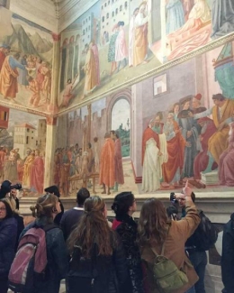 students looking at mural