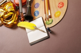 photo of palette, pen, mask, and instruments