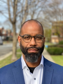 headshot photo of man, outdoors