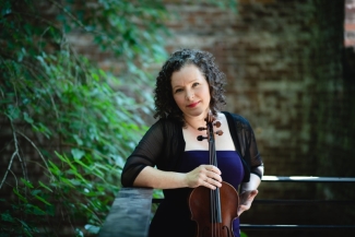 photo of woman holding viola, outdoors