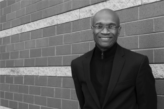 black and white photo of man with wall