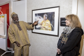 photo of two people and painting