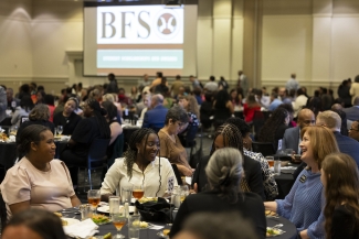 photo of people seated at tables at luncheon