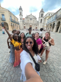 photo of group of people, classical architecture in background, day