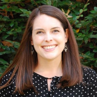 photo of woman, with foliage in background