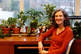 photo of woman in office, seated with window