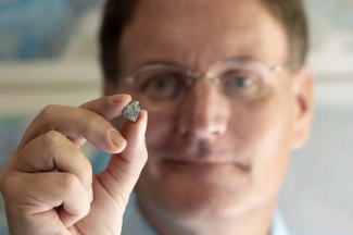 photo of man holding rock in foreground