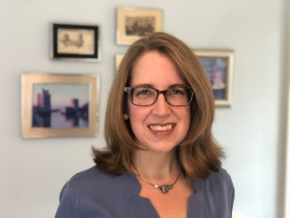 photo of woman, with framed images in background