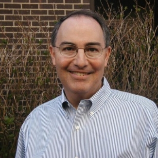 headshot photo of man, outdoors