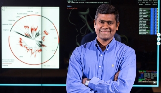 photo of man in front of computer screen projection