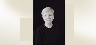 headshot of woman on black back ground with color block