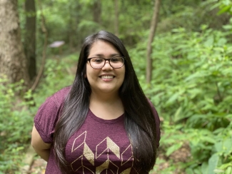 photo of woman outdoors, trees in background