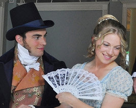 smiling man, woman with fan