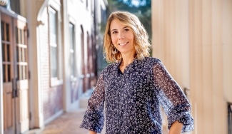 Photo of woman on building porch, day