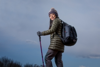 photo of woman on mountain hike, with walking stick