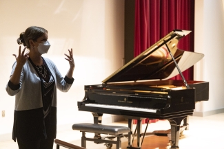 photo of woman with piano in background