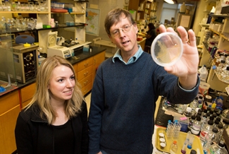 man and student in lab with petri dish