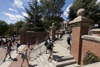 photo of people walking up steps, sunny day
