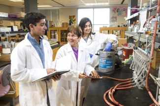 photo of three people in white lab coats, laboratory