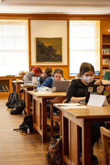 photo of students with computers in library 