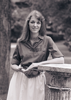 black and white photo of woman outside with pedestal