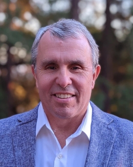 headshot of man, outdoors