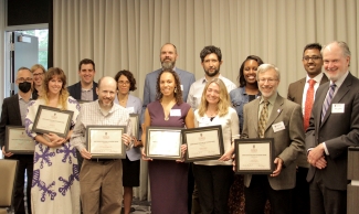 group photo of people holding plaques