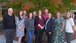 group photo of people, trees in background