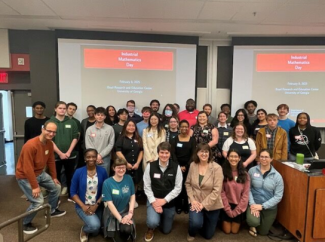 group photo of people, screen in background