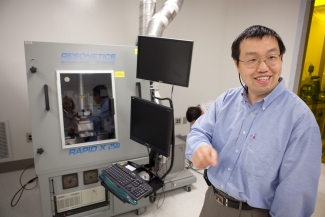 photo of man with computer and diagnostic machine