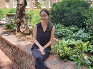 photo of woman posed on low wall, day