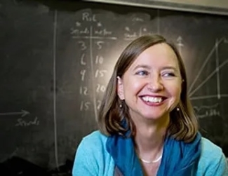 photo of woman, with blackboard in background