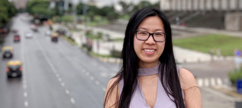 photo of woman outdoors on bridge over highway