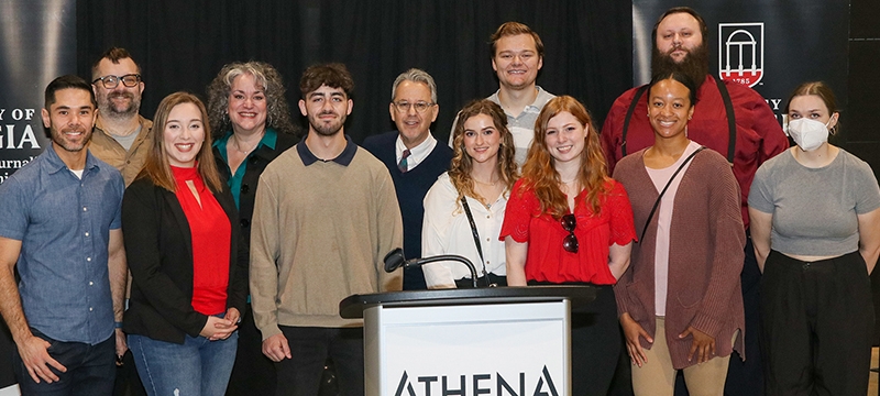 group photo of people behind podium