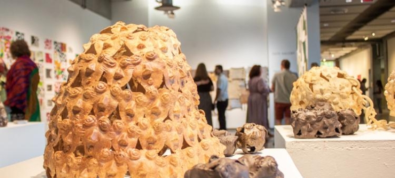 photo of sculpture and people at an art exhibition