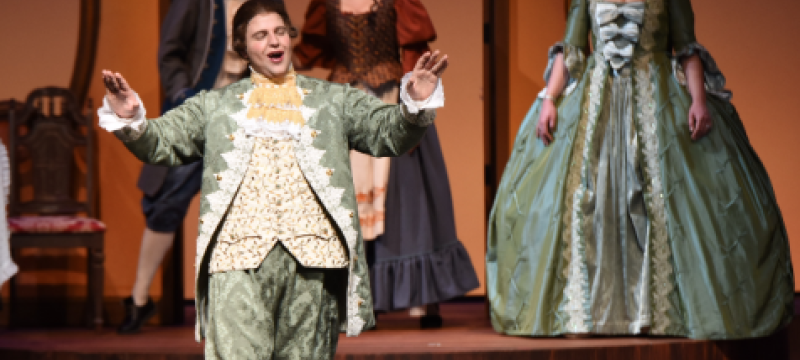 photo of singers in 19th century costumes on stage