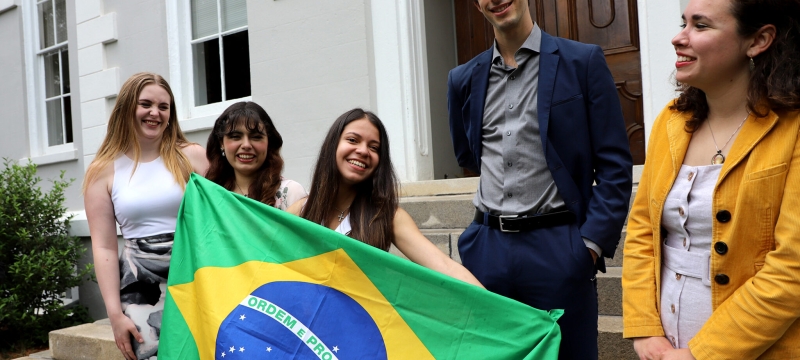 photo of five people with Brazil flag