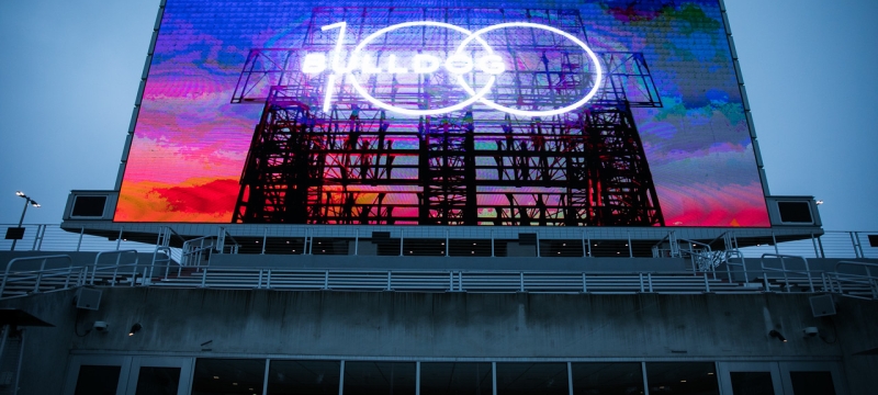 photo of stadium sign illuminated at twilight
