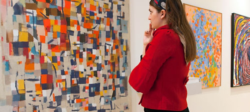 photo of woman studying abstract art