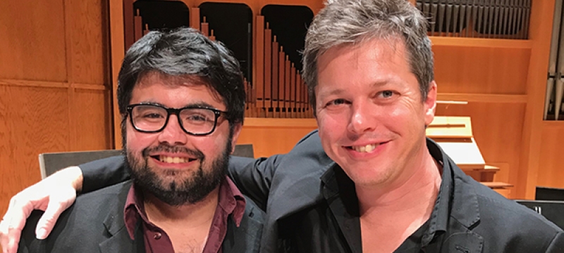 photo of two men in a concert hall