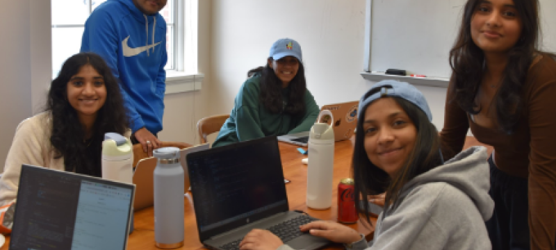 photo of five people with laptop computers