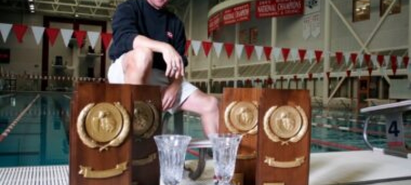 photo of many with trophies and plaques, with pool