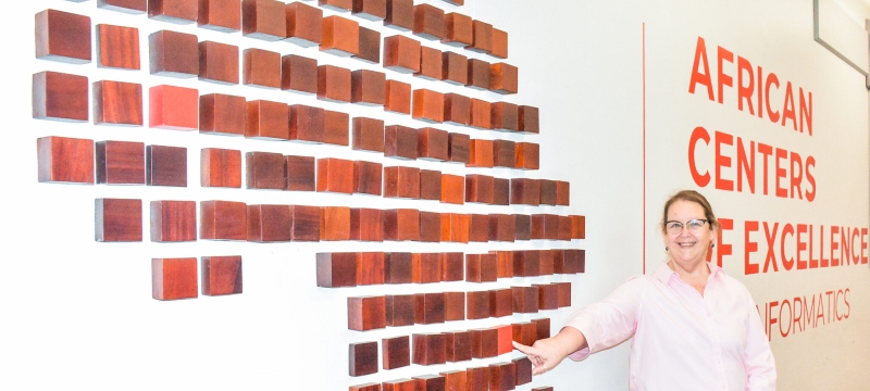 photo of woman standing next to outline of Africa