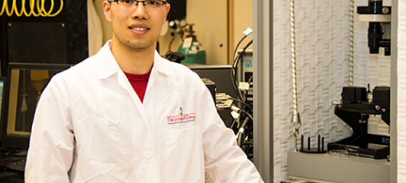 student in lab coat in lab