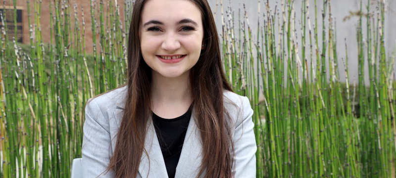 photo of woman, outdoors with bamboo reeds in background