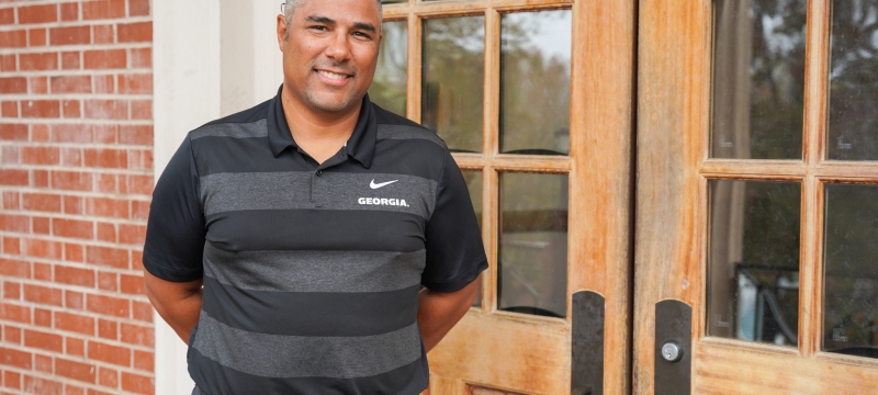 photo of man in front of double doors