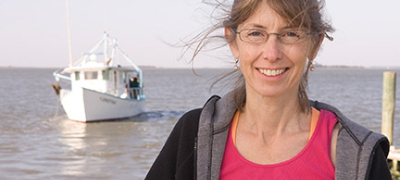 woman outside with water, boat