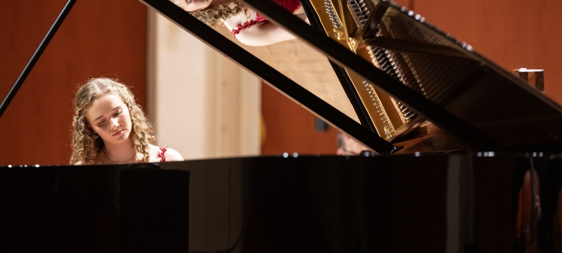 photo of woman playing piano