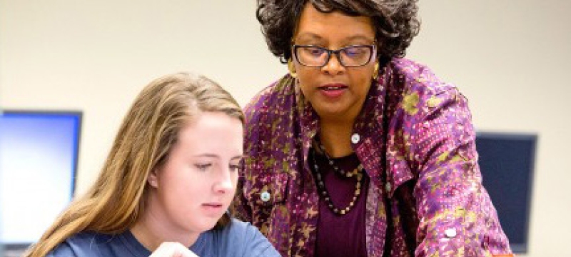 professor with student on computer 